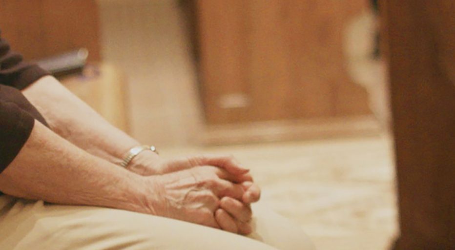 A sister sits in the chapel for prayer during a time of uncertainty.