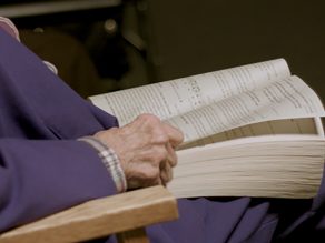 Sister praying for peace with a bible