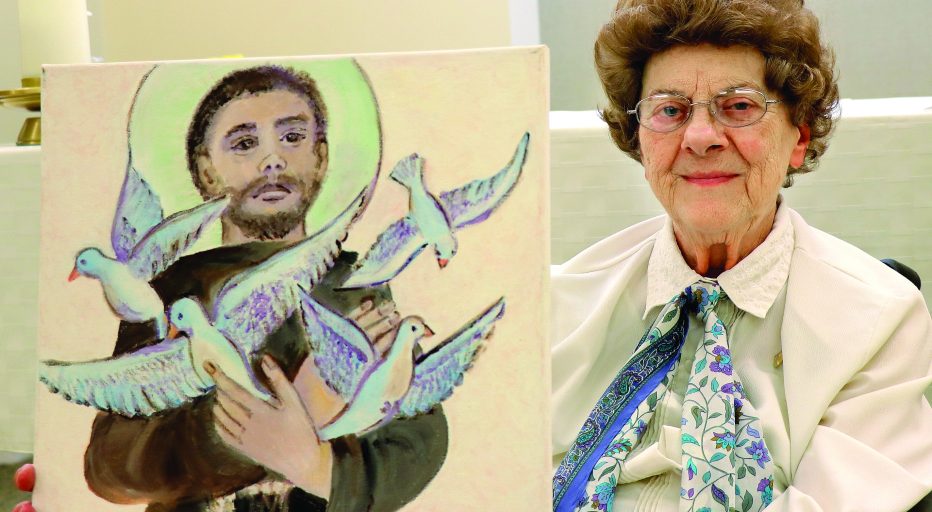 Sister Gwen Floryance with a painting she made of St. Francis of Assisi