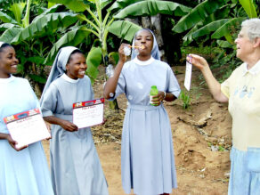 Sister Virginia and three students laughing; one student is blowing bubbles.